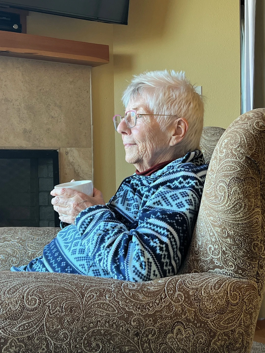 Elizabeth at Cannon Beach, holding a cup of tea